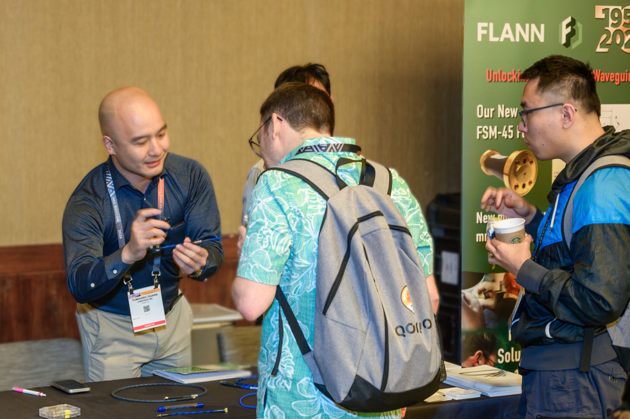 Attendees visit the Flann Microwave exhibit during the ARFTG-107 exhibit break.