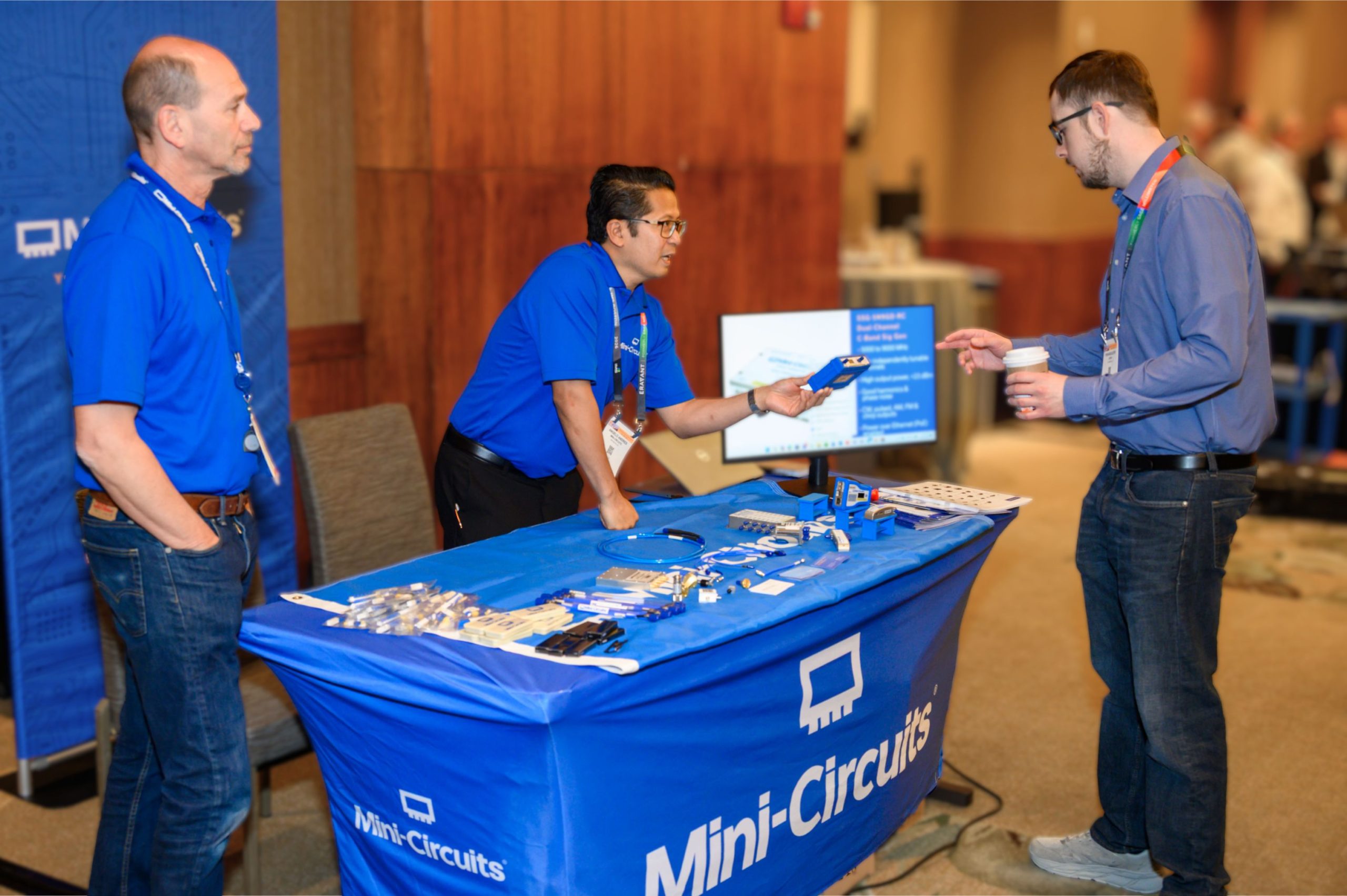 Attendees visit the Mini-Circuits exhibit during the ARFTG-107 exhibit break.